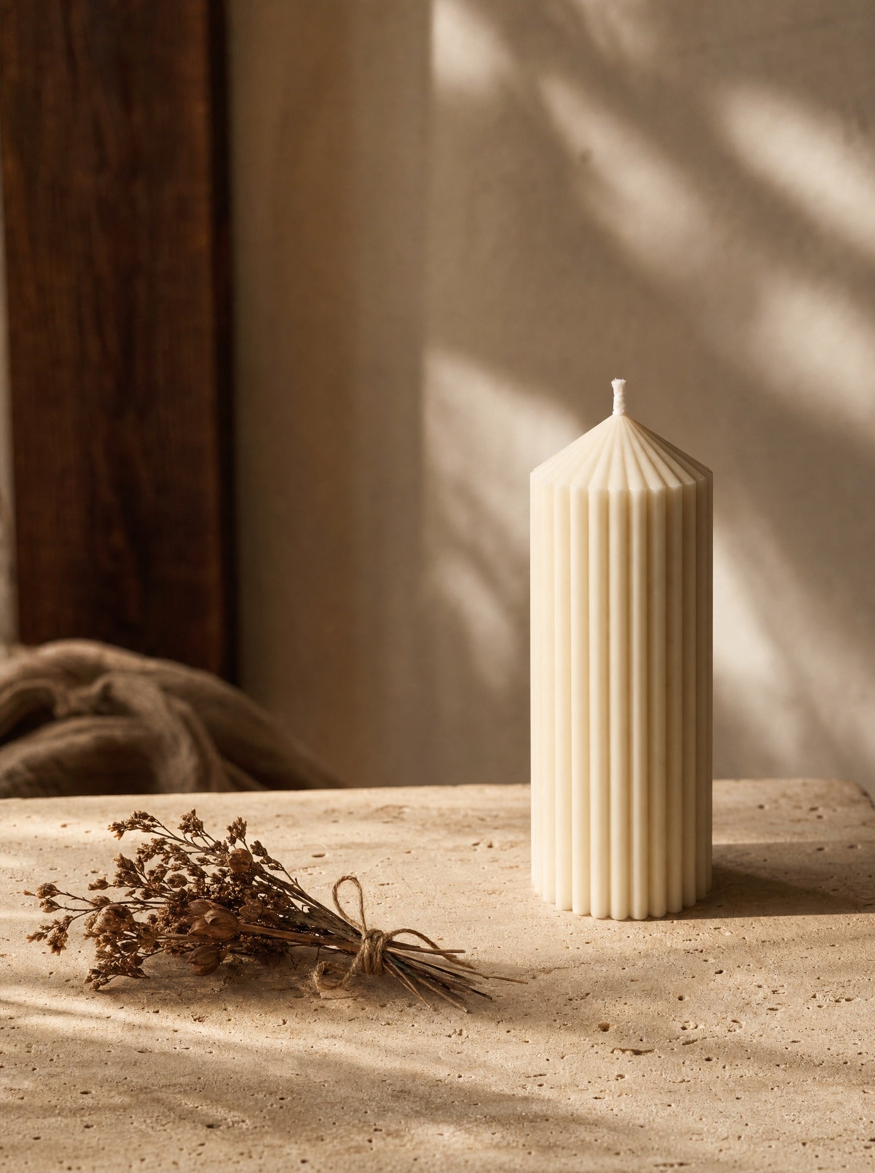 Cream fluted pillar candle by Soul Sent styled as modern sculptural home decor on a stone surface