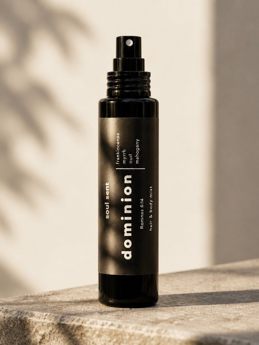 Soul Sent Dominion Hair & Body Mist featuring oud, myrrh, frankincense, coconut, and mahogany fragrance in a black spray bottle.